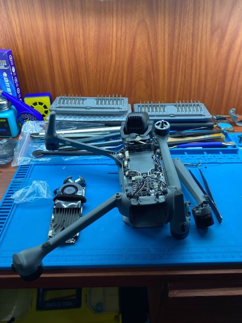 A DJI Mavic disassembled on the bench during a repair